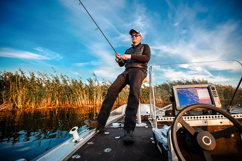 fisherman on a motor boat with spinning